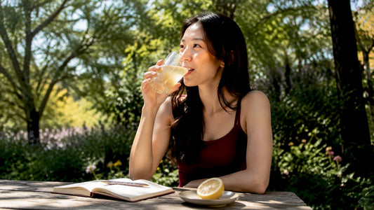Woman tasting tart kombucha drink in café