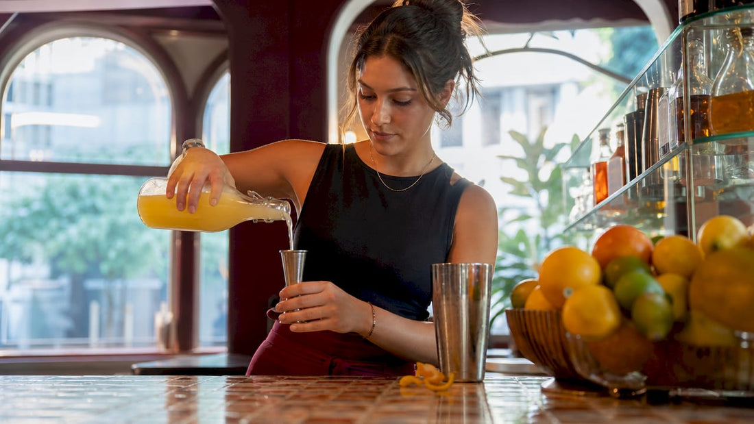 Barista pouring lemon juice to balance sweetness